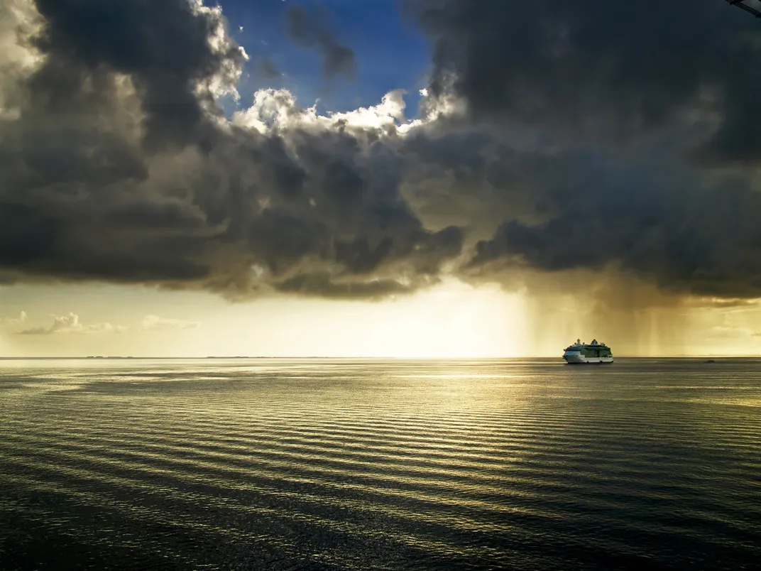 a storm is over a ship at sea