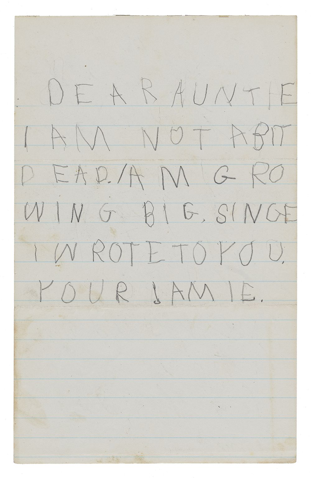 Letter written in pencil and capital letters by a child on blue-lined paper.