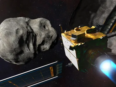 An illustration of the DART spacecraft next to the asteroid, Dimorphos, and the larger asteroid it orbits, Didymos.