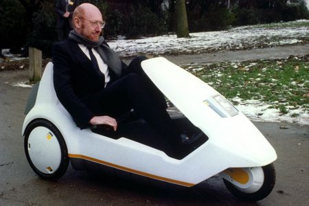 Inventor Sir Clive Sinclair demonstrates his battery-assisted pedal powered tricycle at Alexandra Palace, London.