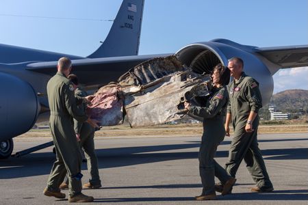 Wisconsin Air National Guard officers carry the wingtip on&nbsp;July 12.