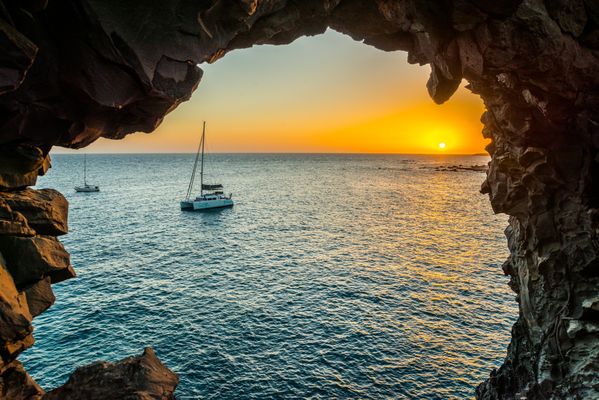Sailing at sunset, view from a cave thumbnail