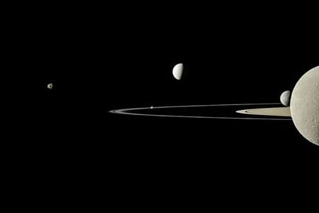 Saturn&#39;s rings and five of its moons, as captured by the Cassini spacecraft in 2011. The five moons, from left to right, are Janus, Pandora, Enceladus, Mimas and Rhea.