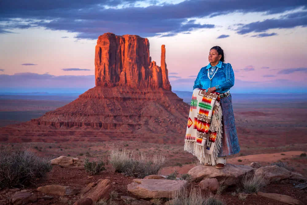 A Native American woman contemplates the beauty of her homeland.