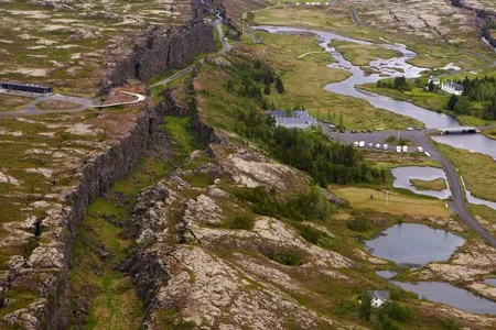 The earth is splitting apart in the middle of Iceland along a ridge that runs north to south through the middle of the Atlantic Ocean.