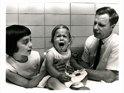 Hilleman's one-year-old daughter Kirsten (center, with her sister Jeryl Lynn and Dr. Robert Weibel) became the first to receive the mumps vaccine.