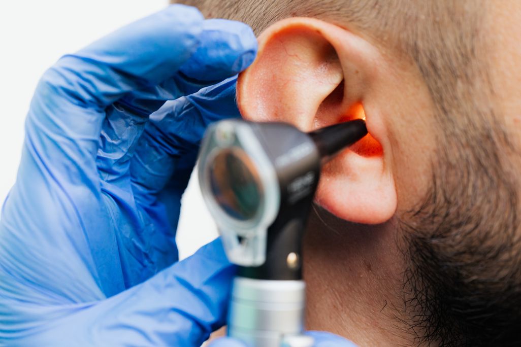 Doctor looking into someone's ear
