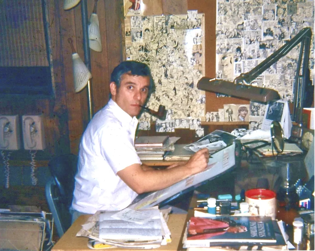 Middle-aged man sitting at a drafting desk