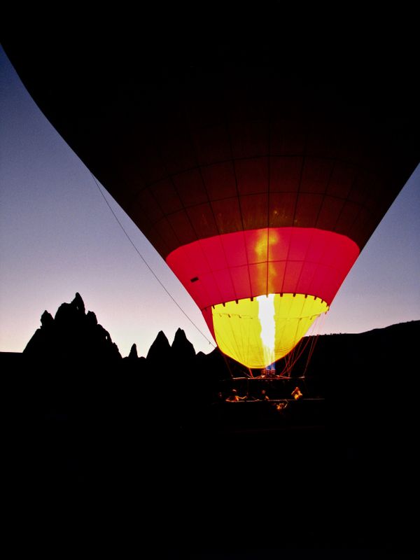 A hot-air balloon begins its rise with flame ablaze in Cappadocia thumbnail