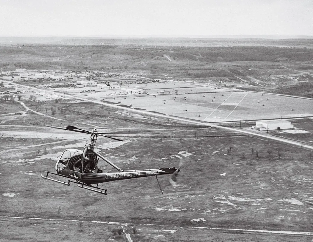 black and white photo of helicopter over training field in Texas