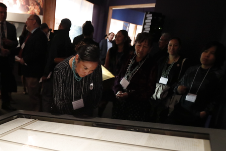 Representatives of the Navajo Nation read the original text of the Naaltsoos Sání, or Navajo Treaty of 1868, after its unveiling in the exhibition 