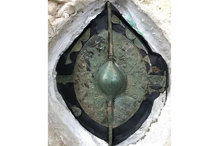 The shield was buried alongside a 2,000-year-old chariot drawn by two horses.