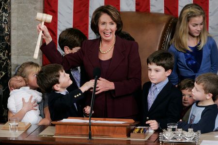 Newly elected Speaker of the House Nancy Pelosi, surrounded by children and grandchildren of members of Congress, holds up her gavel in the U.S. Capitol on Thursday, Jan. 4, 2007.