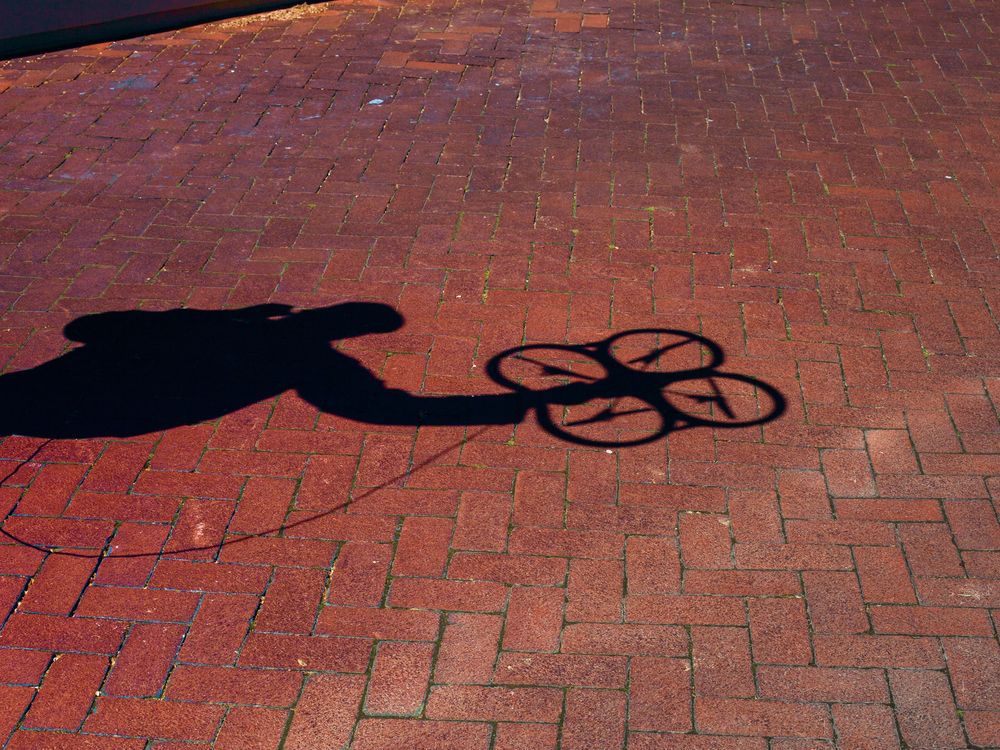 opener: shadow of quadcopter against brick floor