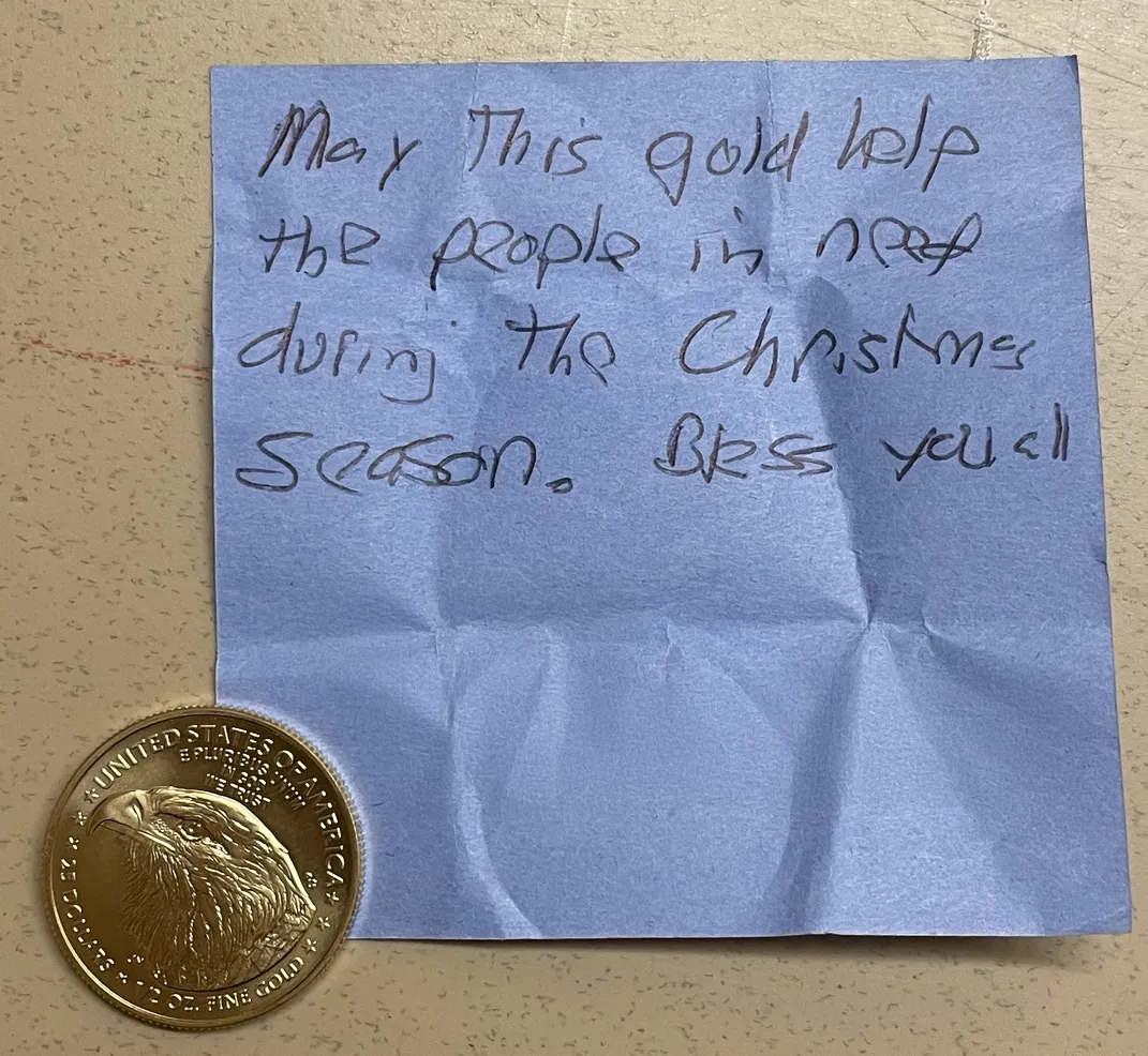 Blue sticky note next to a gold coin