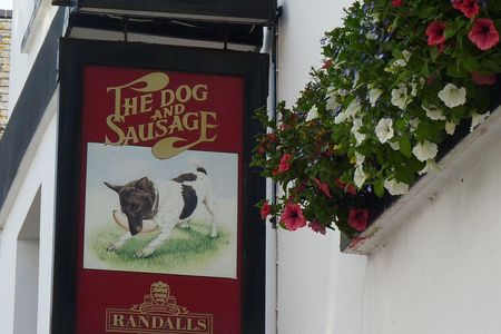 Pub signs illustrat the creative names of local watering holes, like the Dog & Sausage in St. Helier, Jersey. 