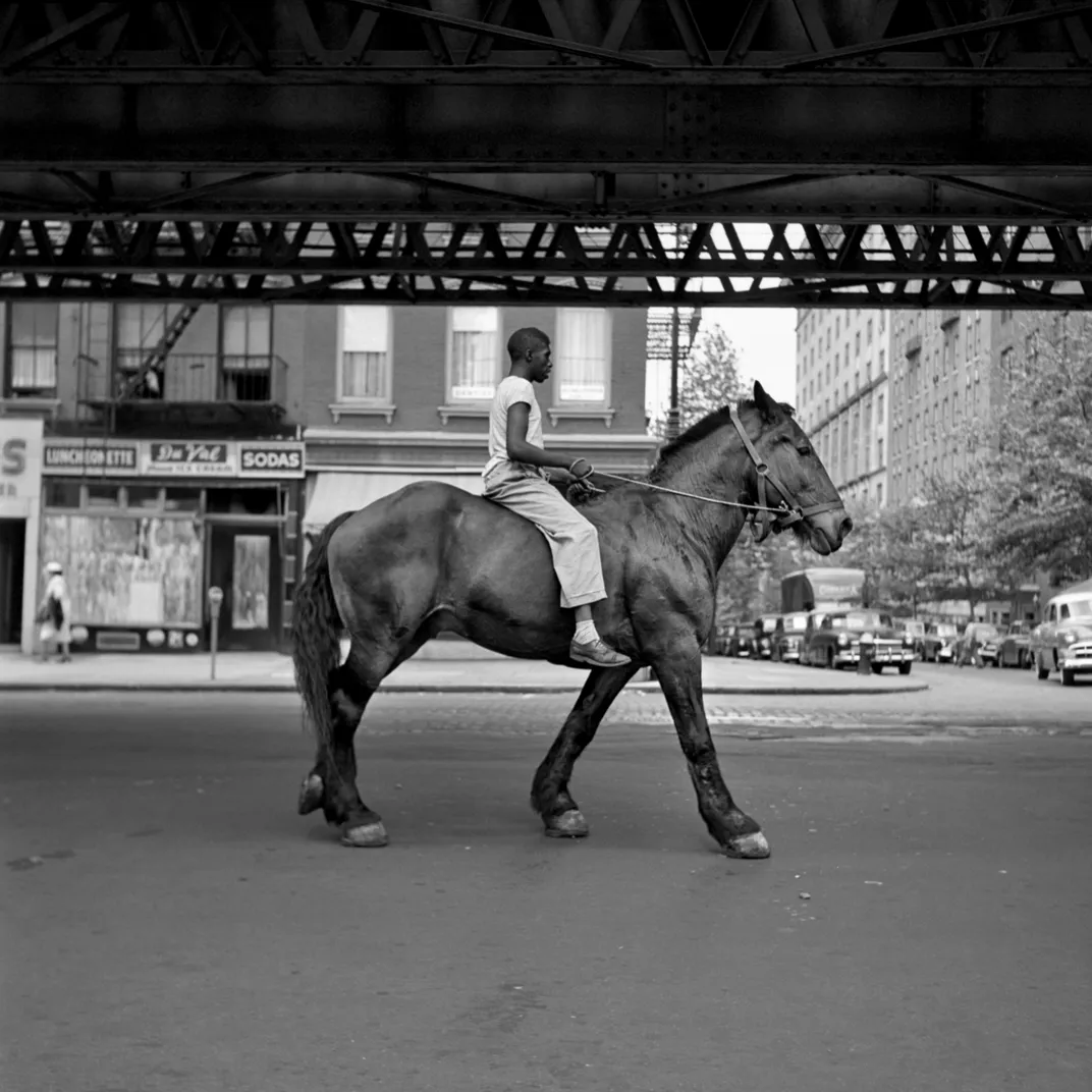 Vivian Maier photographs a man on a horse