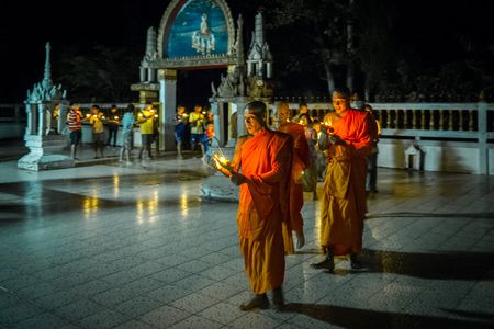 Monks lead a candlelight procession around the ordination hall during Vesak celebrations in rural Nakhon Nayok, Thailand.
