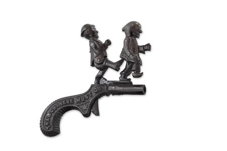 The anti-Chinese cap pistol carries the phrase “The Chinese Must Go” and shows a presumably white man kicking a Chinese man.