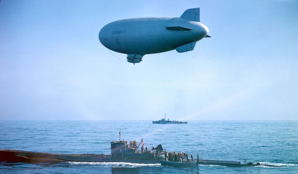 A US flag flies over the captured U-858 as it receives a K-ship escort to Lewes, Delaware. (Official US Navy photograph via National Archives and Records Administration.)