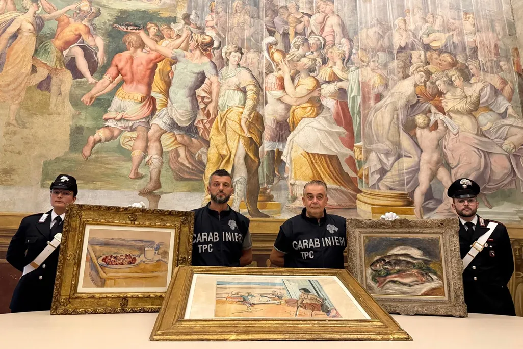 Italian officials with recovered artworks