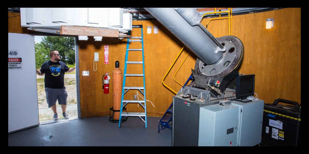 Rankin stands in the doorway to the observatory, wearing sunglasses