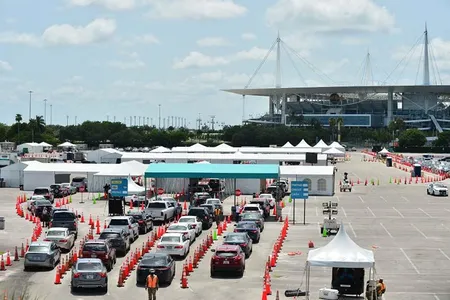 Cars line up at a drive-in coronavirus testing site in Miami Gardens, Florida, in late June. Testing in many states has been hampered by bottlenecks and long delays, problems that could be eased by the rapid, simple tests scientists are now developing.