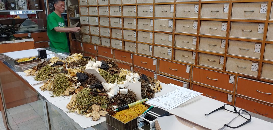 Hong Kong Pharmacy. Pharmacist Drying Herbs Smithsonian Photo Contest
