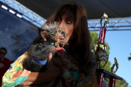 Yvonne Morones embraces her dog Scamp the Tramp after he wins the World's Ugliest Dog contest.