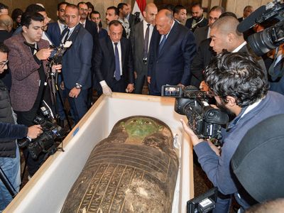 Egyptian officials with the ancient sarcophagus on January 2, 2023