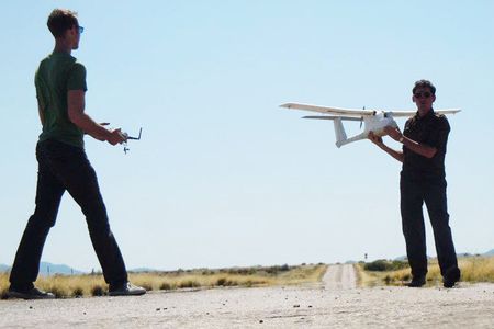 Learning to fly unmanned aircraft can now be part of a college education. A teacher at Arizona’s Embry-Riddle University readies a radio-control airplane for his student’s lesson.
