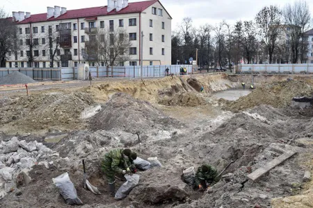 Belarus' servicemen excavate a mass grave for the prisoners of a Jewish ghetto set up by the Nazis during World War II in the city of Brest.