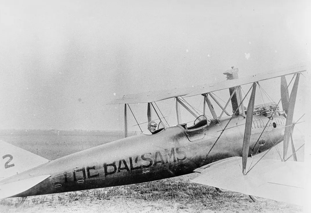 A black and white photo of a small airplane that says The Balsams on it