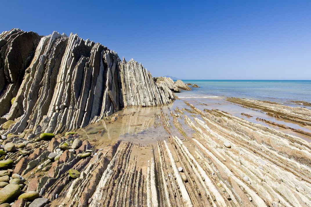 Striated sandstone formations known as flysch along Spain's northern coast