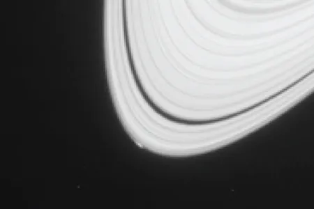 The bright spot on the lower left of Saturn's A ring is not Peggy, but rather the visible sign of Peggy's gravitation distortion of the ring structure.