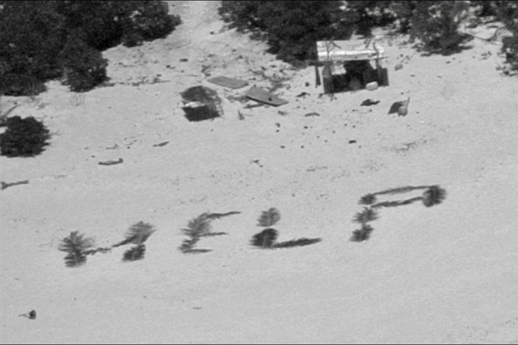 HELP spelled out on beach