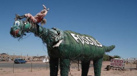 One of the sad dinosaurs at Stewart's Petrified Wood near Petrified Forest National Park in Arizona.