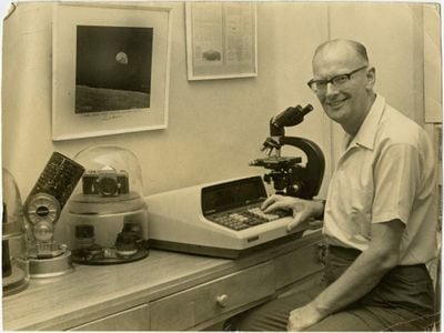 Arthur C. Clarke poses for a photo while he sits at his desk, circa 1969.
