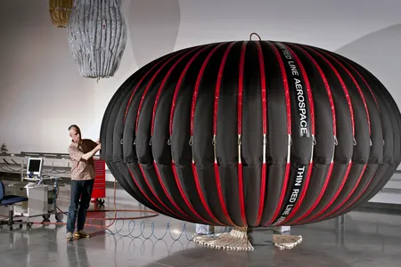 Thin Red Line Aerospace Chief Engineer and CEO Maxim de Jong inspects a UW-CAES “Energy Bag” during initial test inflation 