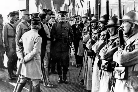 In this June 13, 1917 file photo, U.S. Army General John J. Pershing, center, inspects French troops at Boulogne, France