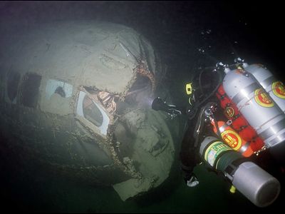 In this 2003 photo, an archaeologist inspects damage to the nose of the B-29 that sank in Nevada's Lake Mead in 1948.