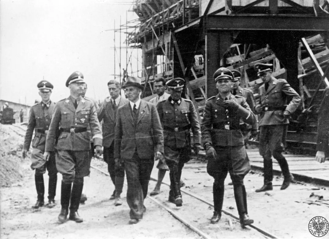 Heinrich Himmler (with glasses at left), head of the SS, visits the IG Farben plant at Auschwitz III in July 1942.