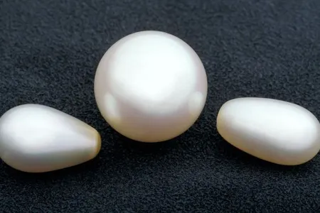 Smooth pearls in the shape of orbs and ovals are usually created by bivalves, like mussels, in pearl farms. As with all gems, the less blemishes they have, the more valuable they are. 