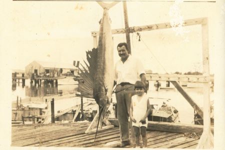 Ernest Hemingway and his middle son, Patrick, pose with a record 119.5-pound Atlantic sailfish caught off Key West, Florida, in May 1934.