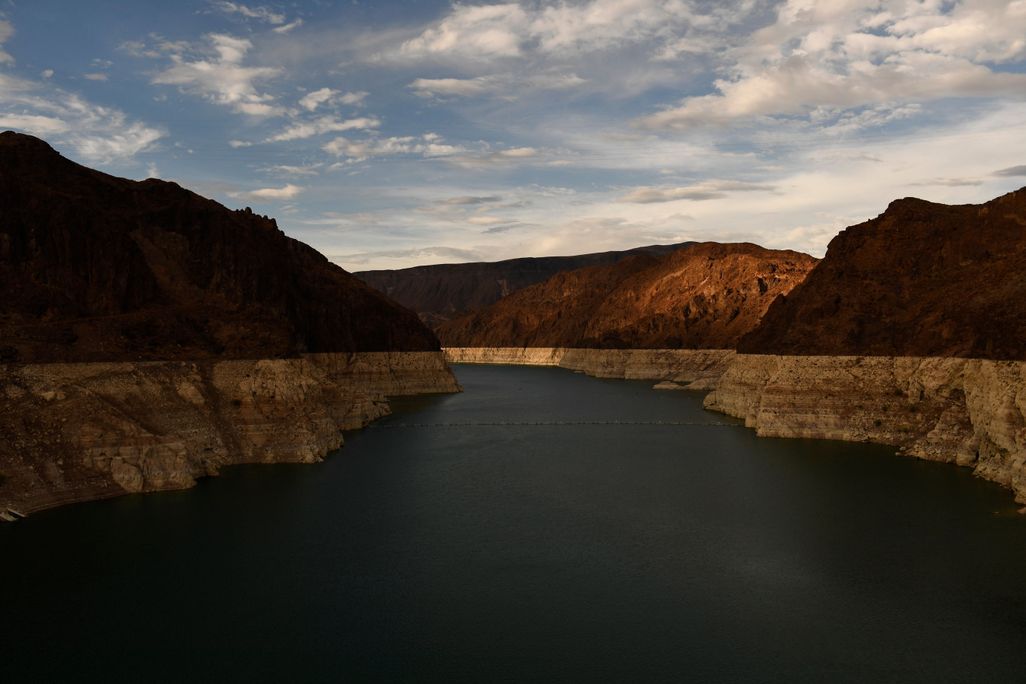 water in a lake appears several feet lower than a line on the canyon walls where it used to reach