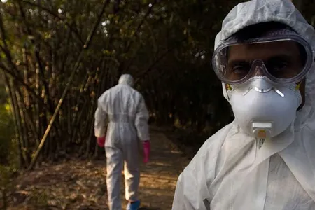 Healthcare providers leave a village after completion of a culling operation in response to a bird flu outbreak in Budgebudge, West Bengal, India.