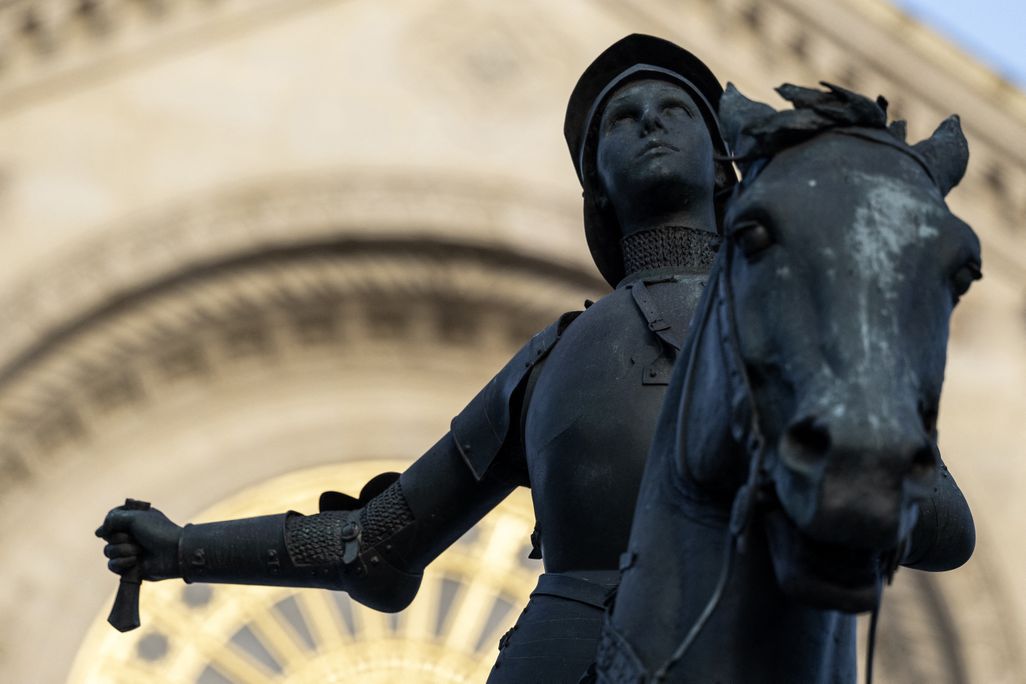 A statue of a woman riding a horse with a missing statue
