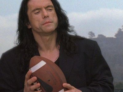 Tommy Wiseau clutches a football in ‘The Room,’ the 2003 film he wrote, produced and starred in.