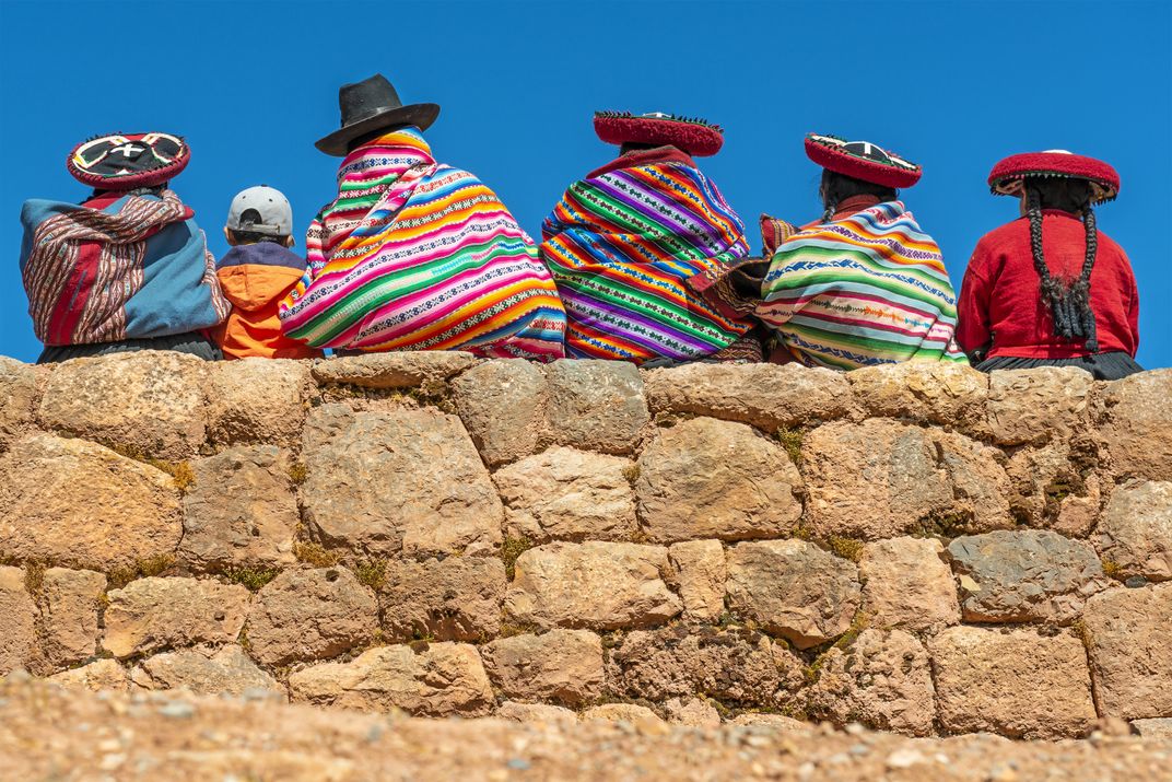 Quechua women sitting on a wall in the Sacred Valley