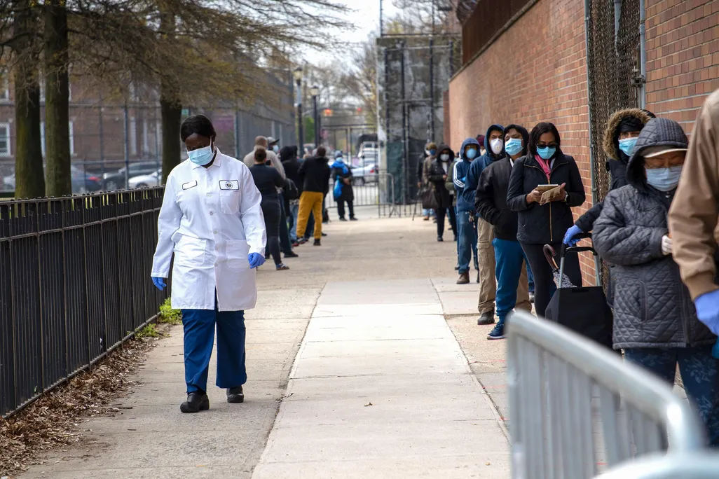 a line, mostly of people of color, waiting for COVID-19 tests in Brooklyn